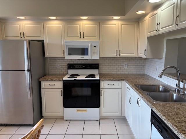 12651 Southwest 16th Court, Unit 413B Pembroke Pines, FL 33027 - Photo 50 of 66 a kitchen with stainless steel appliances granite countertop a stove a refrigerator and a sink