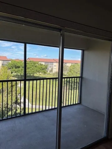 a room with a table chairs and a window