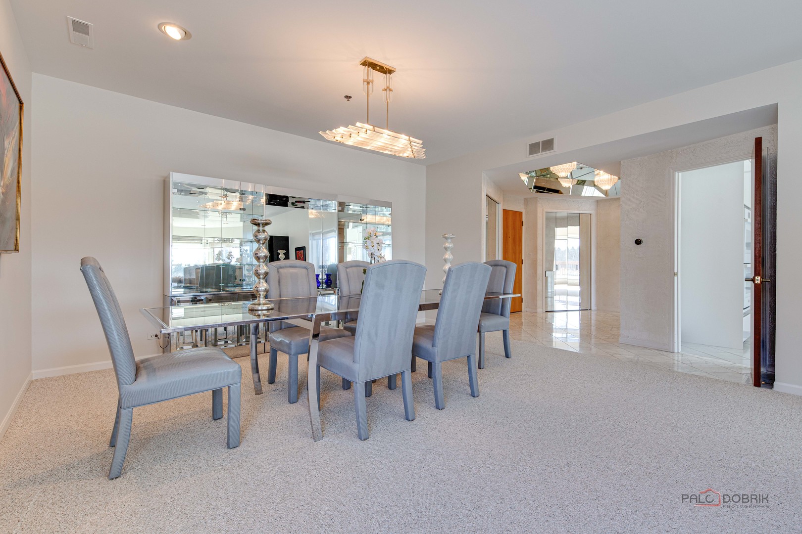 209 Rivershire Lane, Unit 203 Lincolnshire, IL 60069 - Photo 12 of 50 a view of a dining room with furniture and chandelier