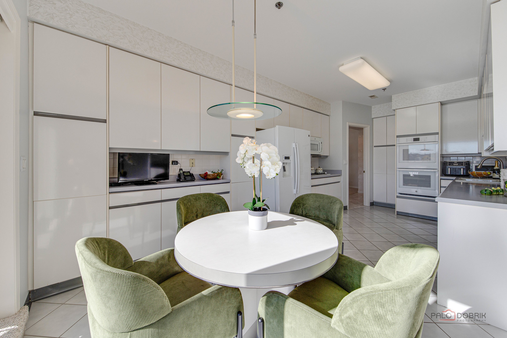 209 Rivershire Lane, Unit 203 Lincolnshire, IL 60069 - Photo 17 of 50 a kitchen with stainless steel appliances kitchen island granite countertop a dining table chairs and a refrigerator