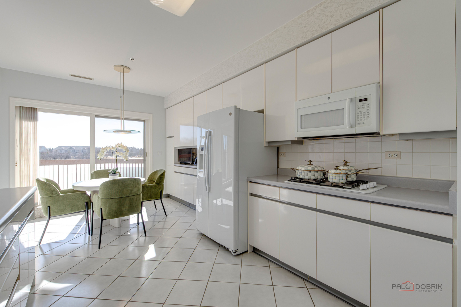 209 Rivershire Lane, Unit 203 Lincolnshire, IL 60069 - Photo 19 of 50 a kitchen with stainless steel appliances granite countertop a stove a refrigerator a sink and white cabinets with wooden floors