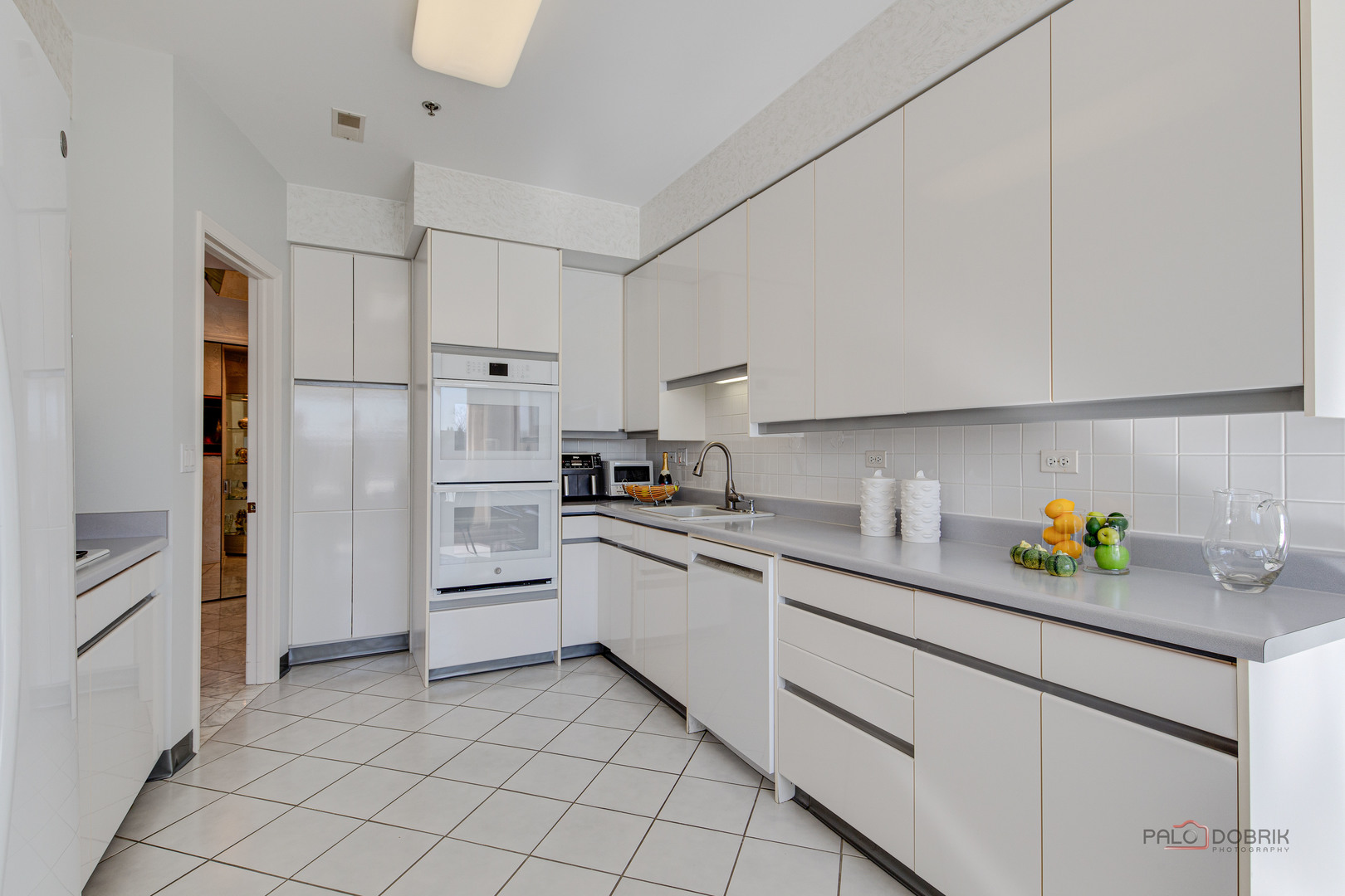 209 Rivershire Lane, Unit 203 Lincolnshire, IL 60069 - Photo 21 of 50 a kitchen with cabinets stainless steel appliances and a counter space