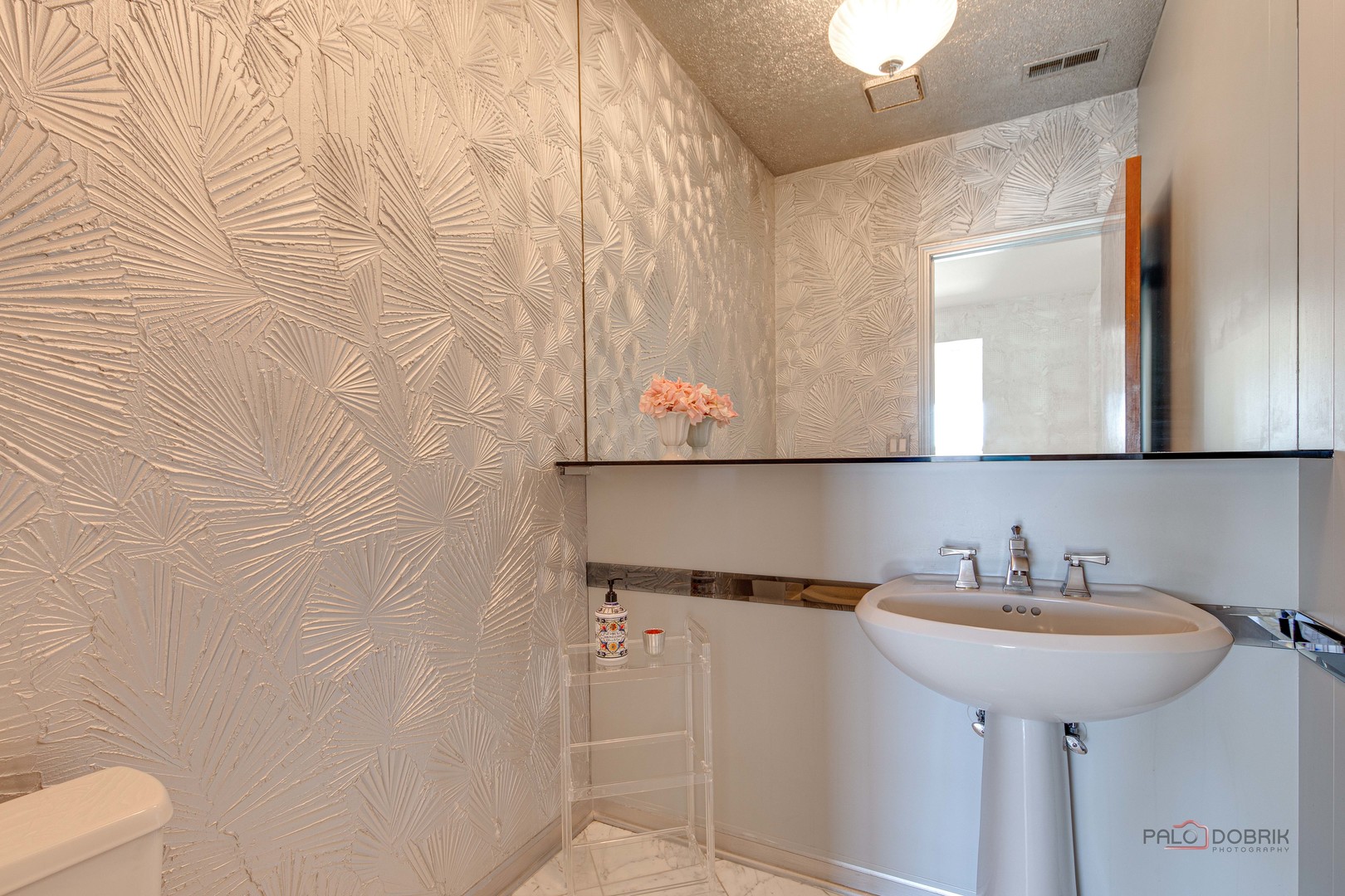 209 Rivershire Lane, Unit 203 Lincolnshire, IL 60069 - Photo 26 of 50 a bathroom with a sink and a mirror
