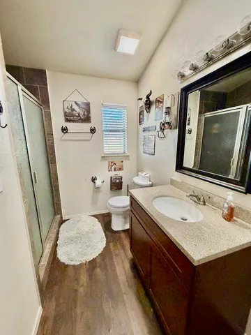 a bathroom with a sink a toilet a mirror and tub