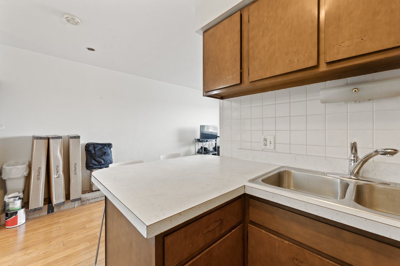 4623 North Chester Avenue, Unit 206 Chicago, IL 60656 - Photo 6 of 19 a kitchen with a sink cabinets and stainless steel appliances