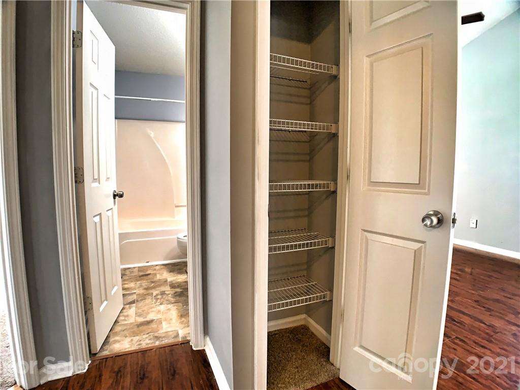 1524 Capps Hill Mine Road Charlotte, NC 28216 - Photo 19 of 32 a view of walk in closet with wooden floor