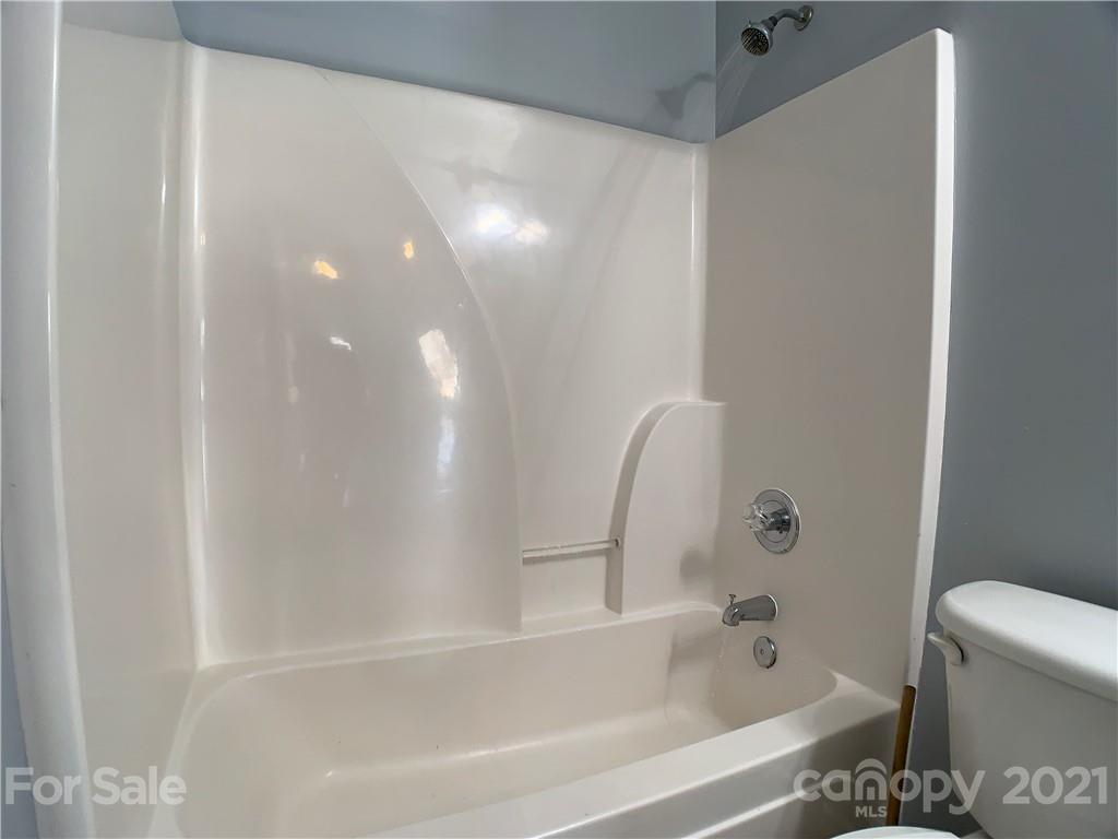 1524 Capps Hill Mine Road Charlotte, NC 28216 - Photo 28 of 32 a bathroom with a bathtub and a toilet