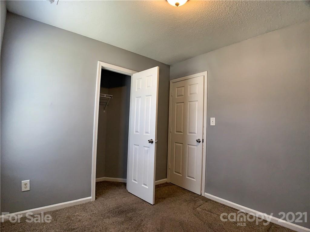1524 Capps Hill Mine Road Charlotte, NC 28216 - Photo 32 of 32 an empty room with closet