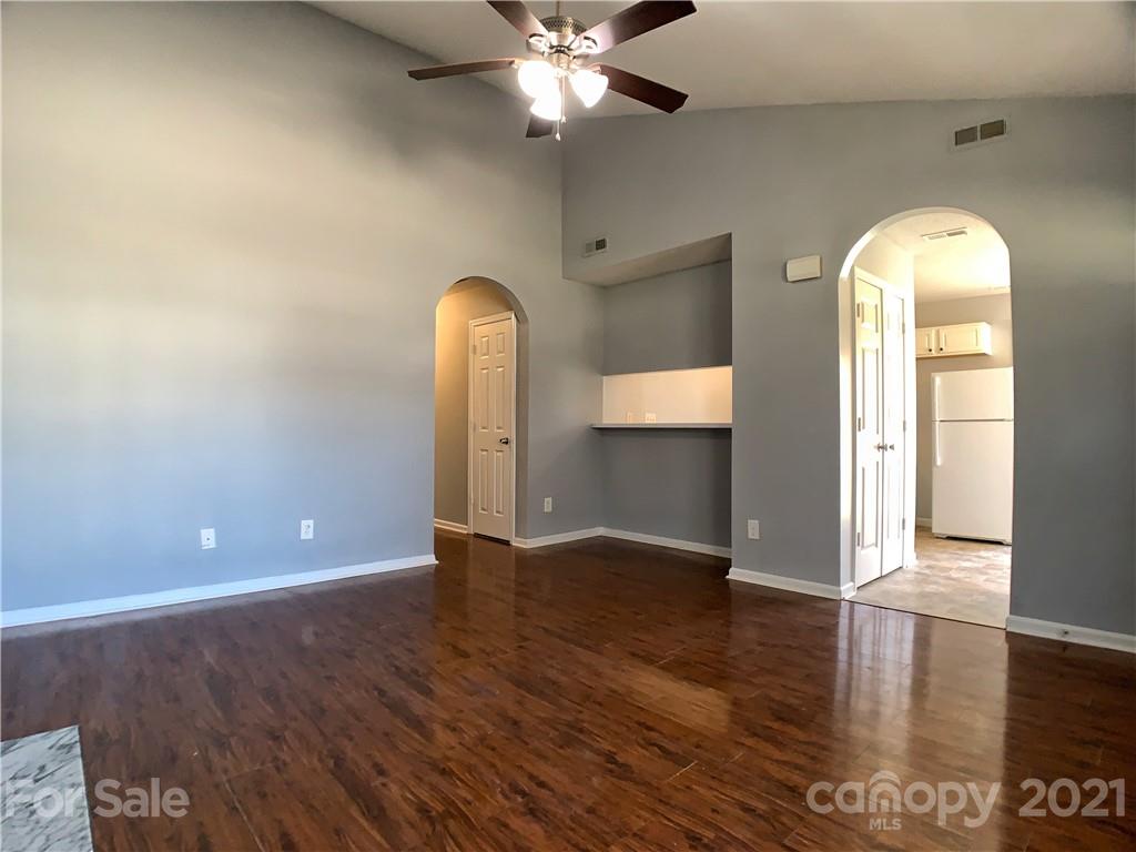 1524 Capps Hill Mine Road Charlotte, NC 28216 - Photo 8 of 32 a view of an empty room with window and wooden floor