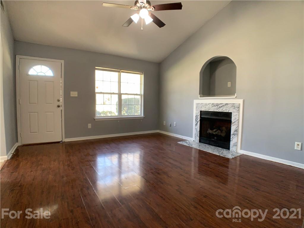 1524 Capps Hill Mine Road Charlotte, NC 28216 - Photo 9 of 32 a view of empty room with wooden floor and fan