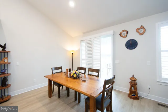 a view of a room with furniture and wooden floor