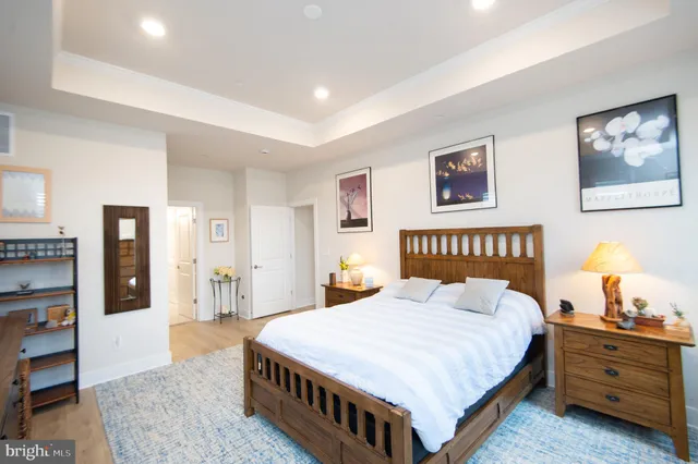 a spacious bedroom with a large bed and a furniture