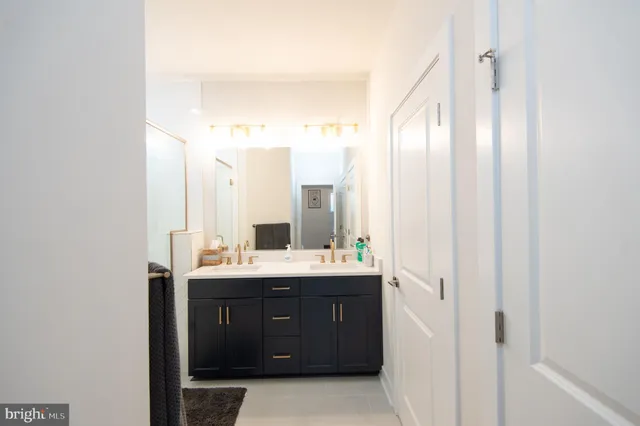 a bathroom with a double vanity sink mirror and