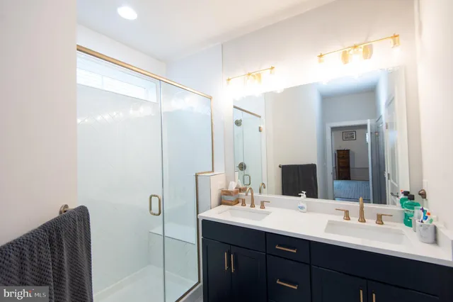 a bathroom with a double vanity sink mirror and double