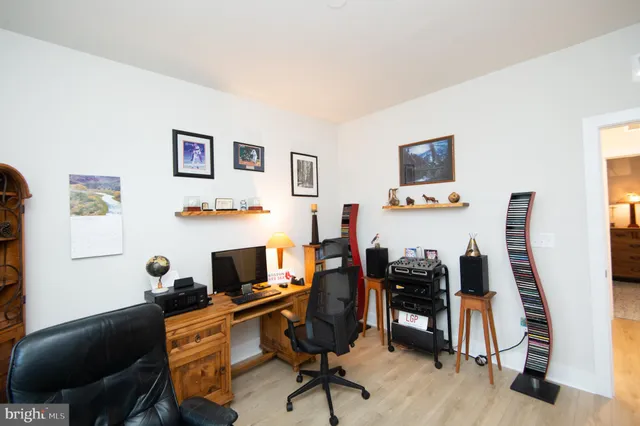a view of a workspace with furniture and a flat screen tv