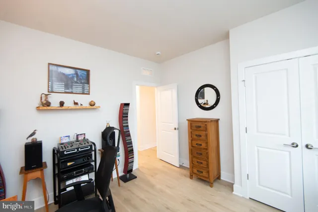 a view of a workspace with furniture and wooden floor