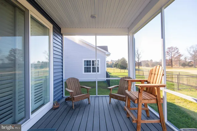 a living room filled with furniture and a floor to ceiling window