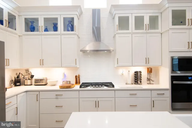 a kitchen with cabinets appliances and a window