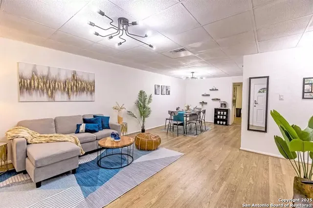 a living room with furniture and wooden floor