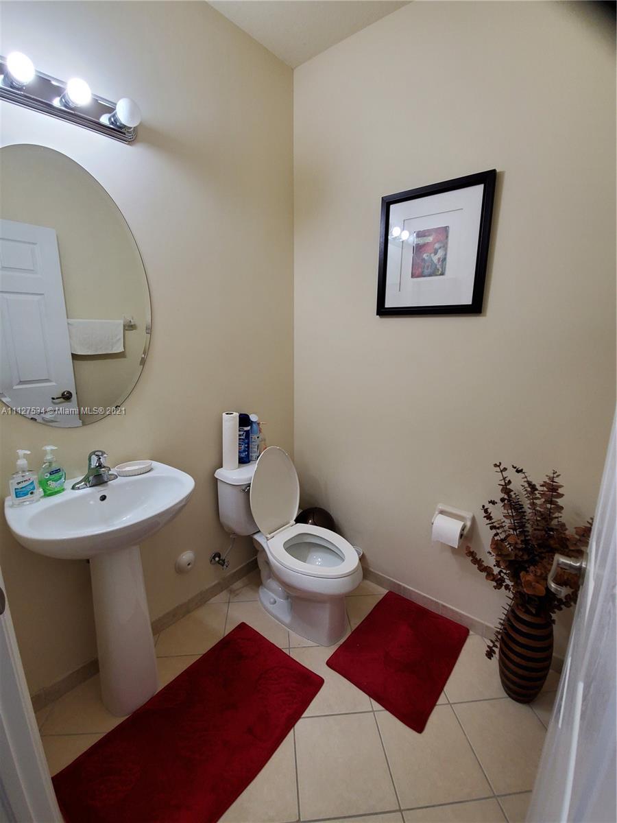 24075 Southwest 113 Passage Homestead, FL 33032 - Photo 12 of 35 a bathroom with a sink mirror and toilet