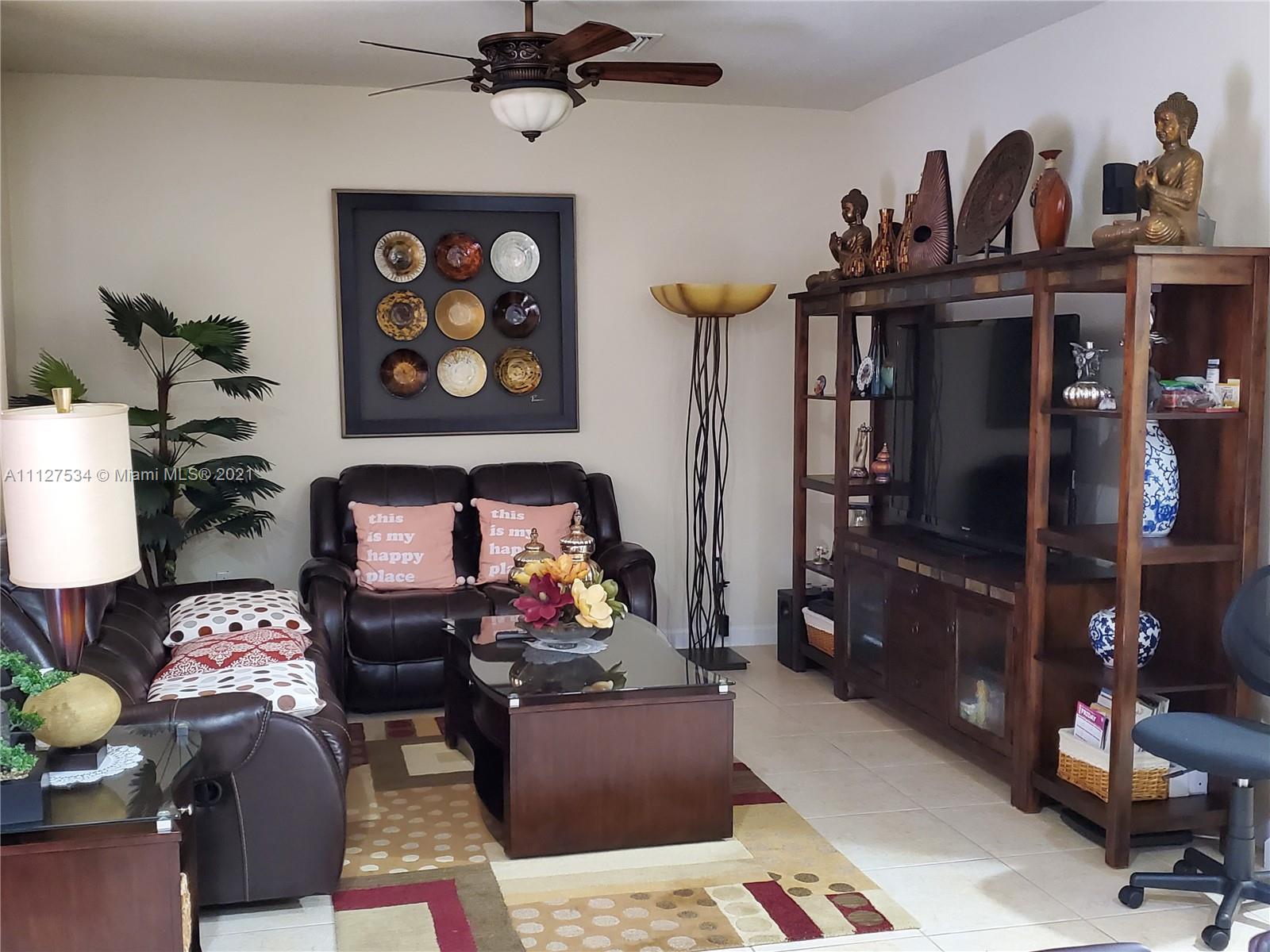 24075 Southwest 113 Passage Homestead, FL 33032 - Photo 13 of 35 a living room with furniture a rug and a closet