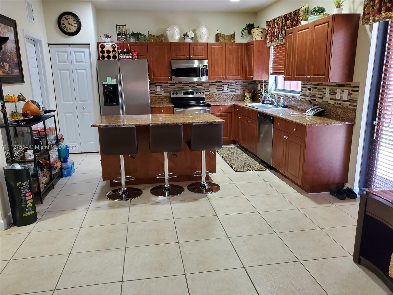 24075 Southwest 113 Passage Homestead, FL 33032 - Photo 14 of 35 a kitchen with stainless steel appliances a sink counter space and a view of kitchen