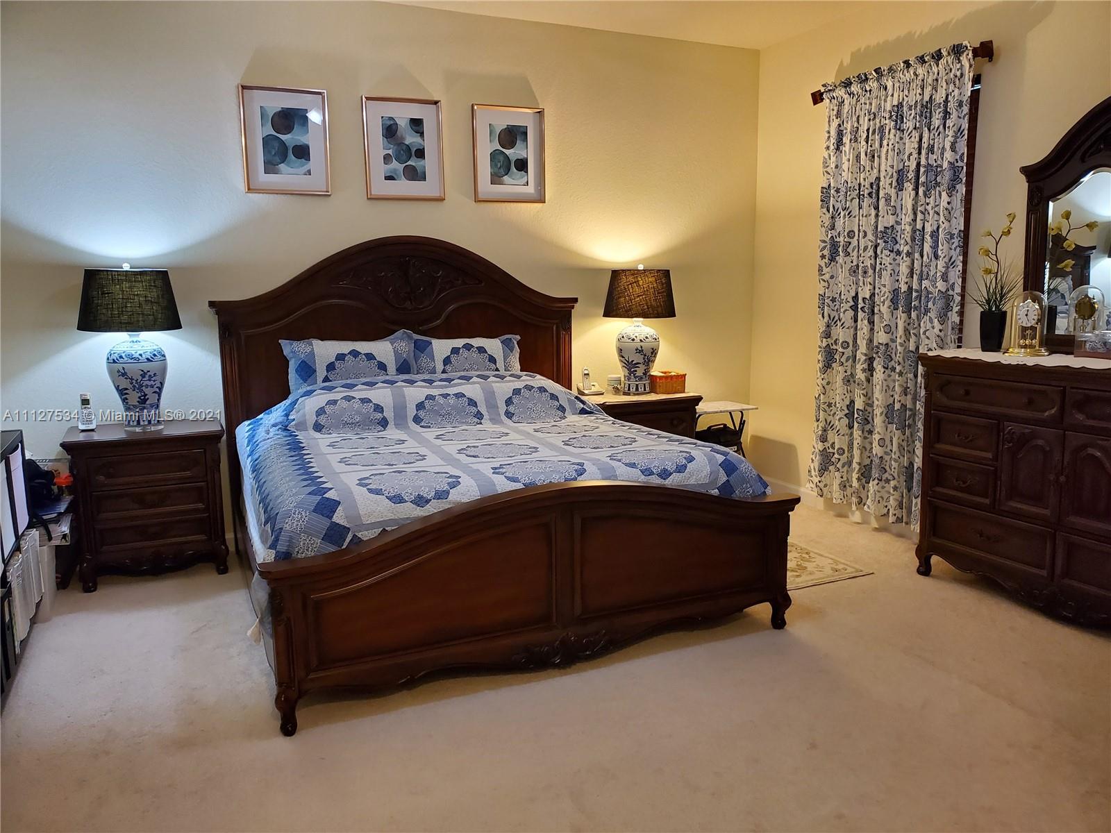 24075 Southwest 113 Passage Homestead, FL 33032 - Photo 23 of 35 a bedroom with a bed and a dresser