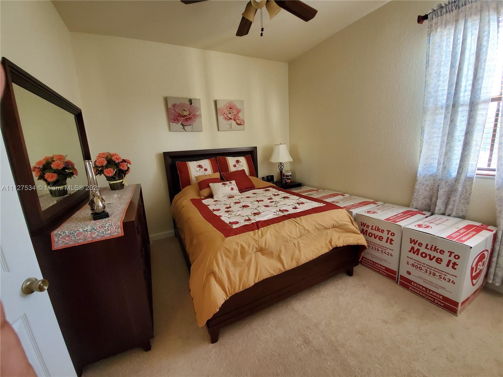 24075 Southwest 113 Passage Homestead, FL 33032 - Photo 25 of 35 a bedroom with a bed and a dresser in it