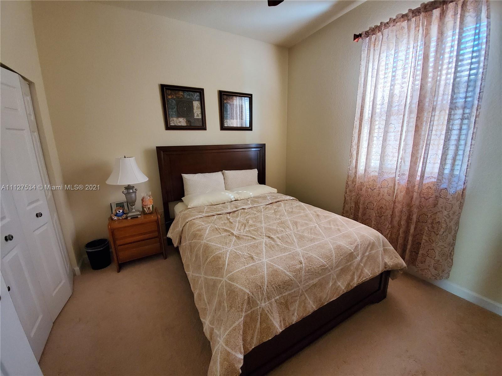 24075 Southwest 113 Passage Homestead, FL 33032 - Photo 26 of 35 a bedroom with a bed and a window