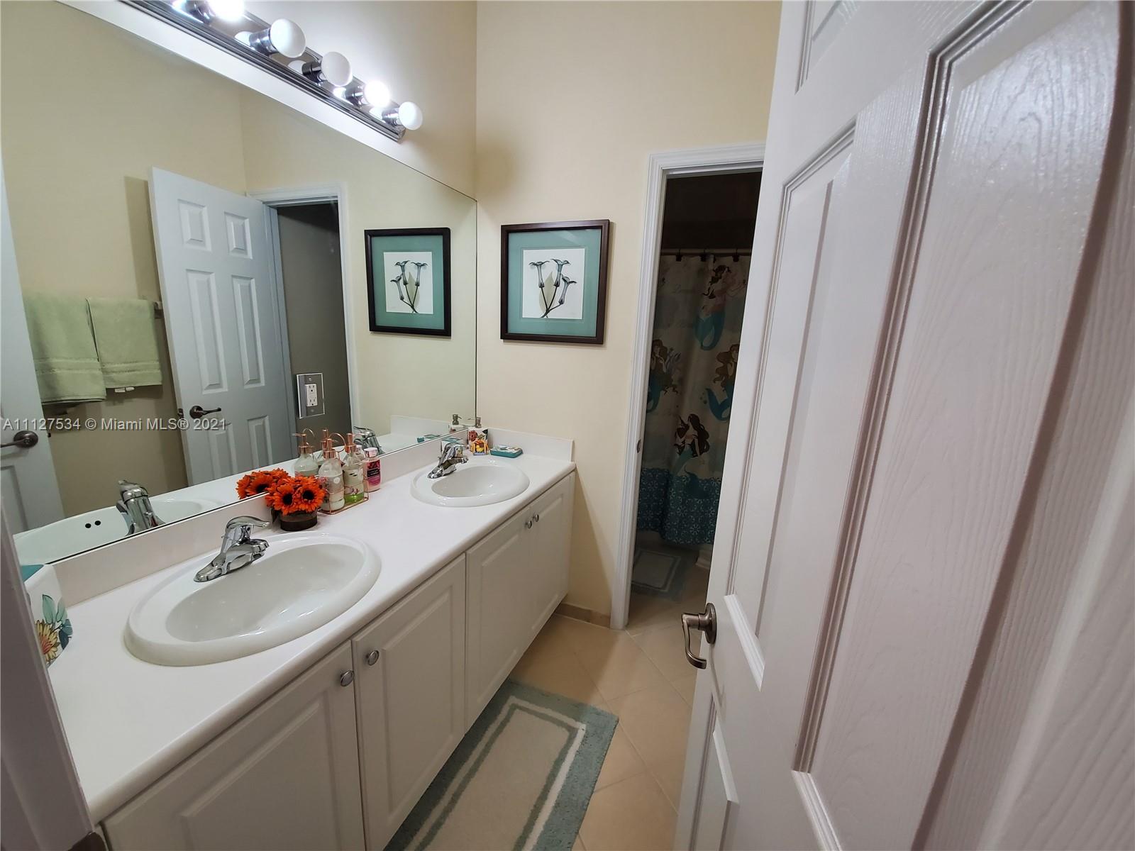 24075 Southwest 113 Passage Homestead, FL 33032 - Photo 30 of 35 a bathroom with a sink and a mirror