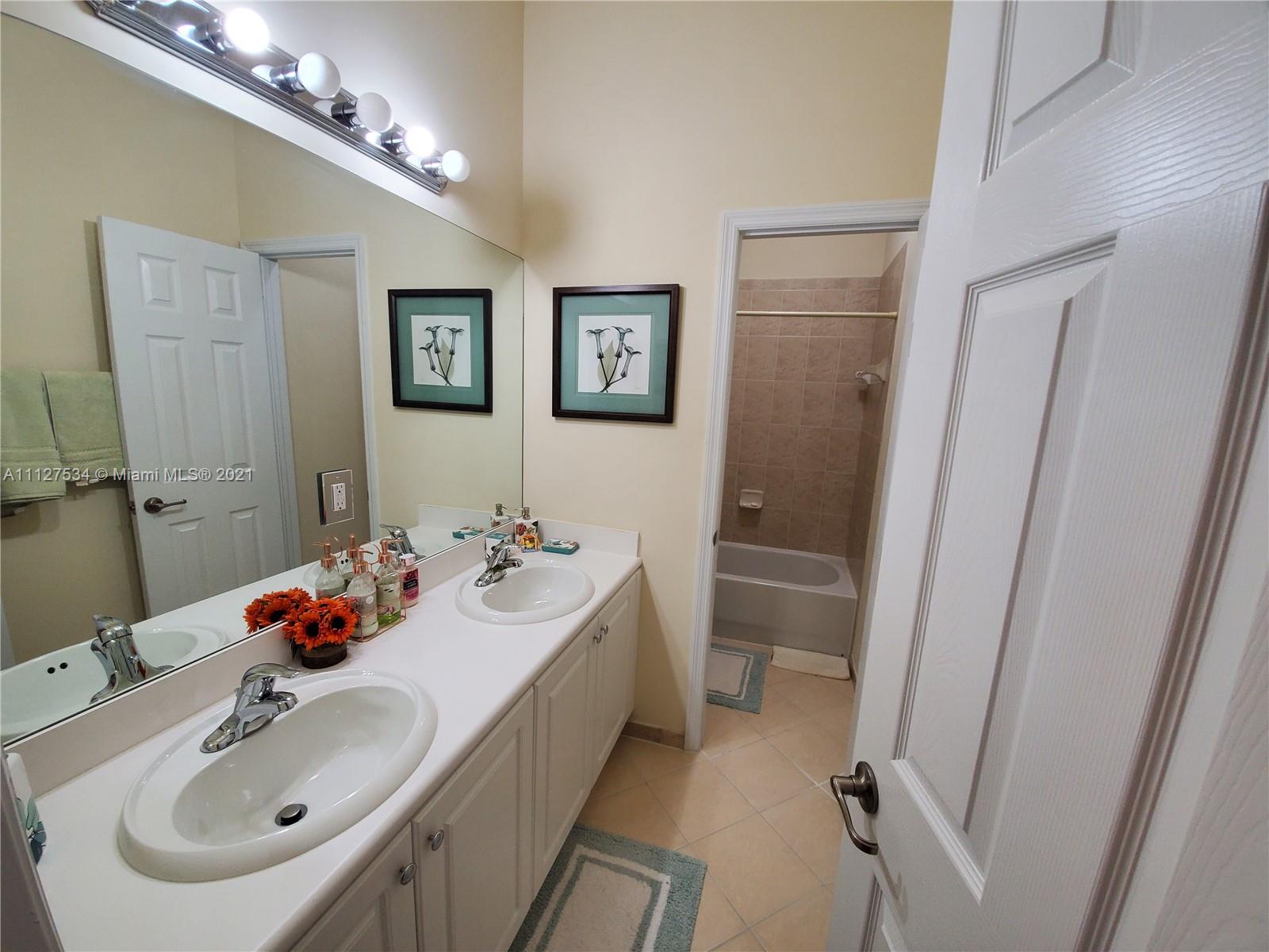 24075 Southwest 113 Passage Homestead, FL 33032 - Photo 31 of 35 a bathroom with a sink and a mirror