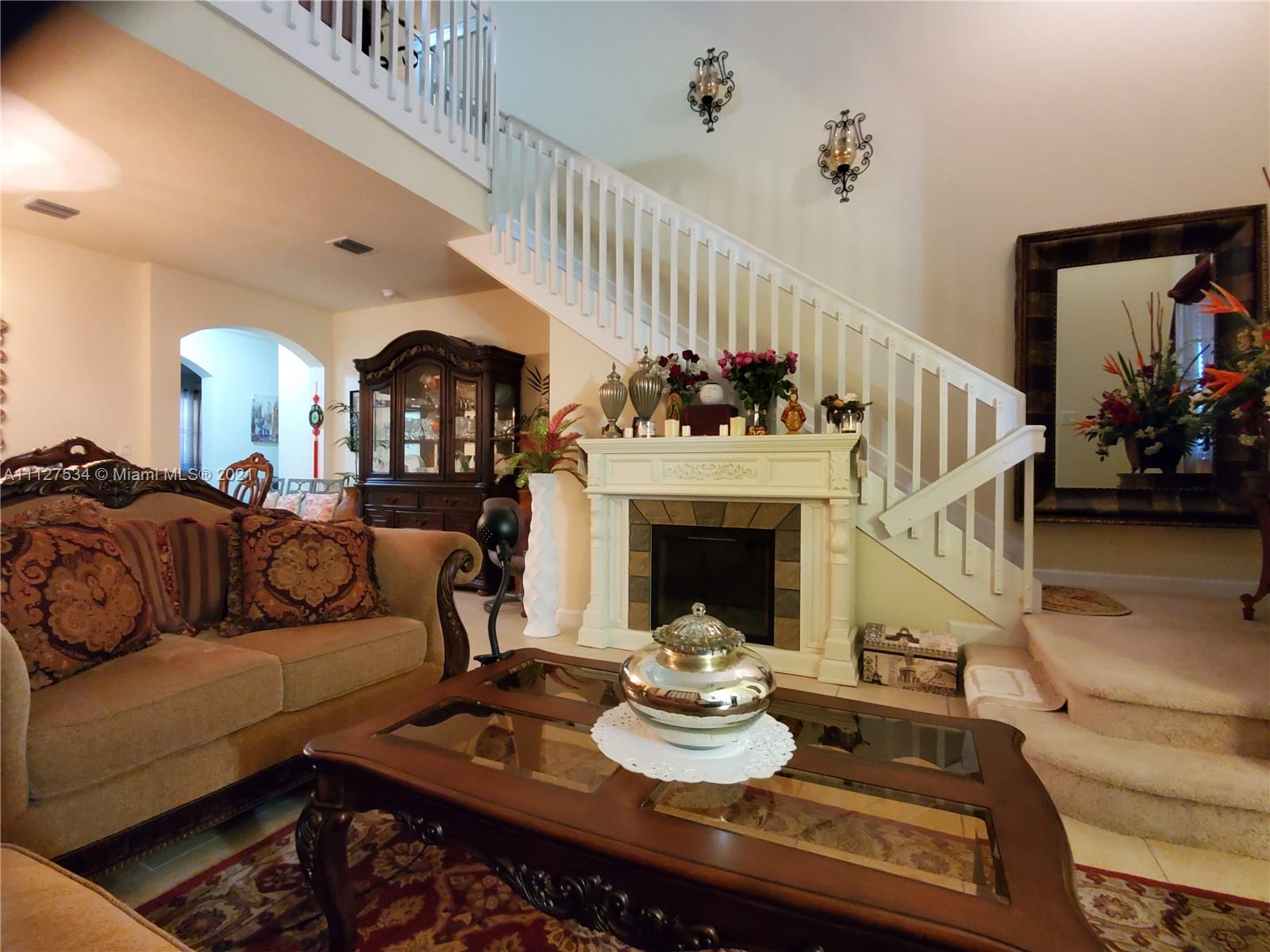24075 Southwest 113 Passage Homestead, FL 33032 - Photo 8 of 35 a living room with furniture and a fireplace