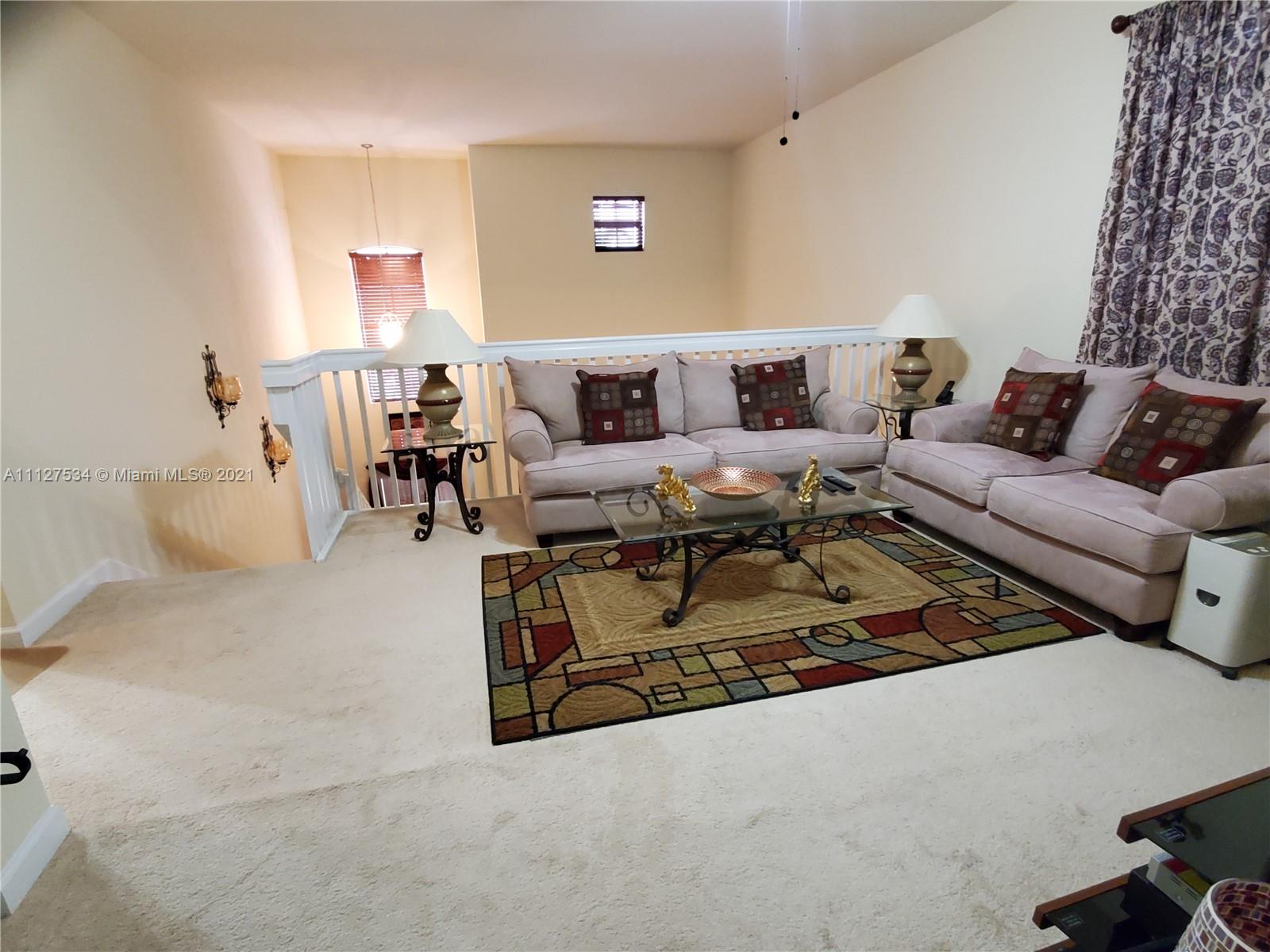 24075 Southwest 113 Passage Homestead, FL 33032 - Photo 9 of 35 a living room with furniture and a couch