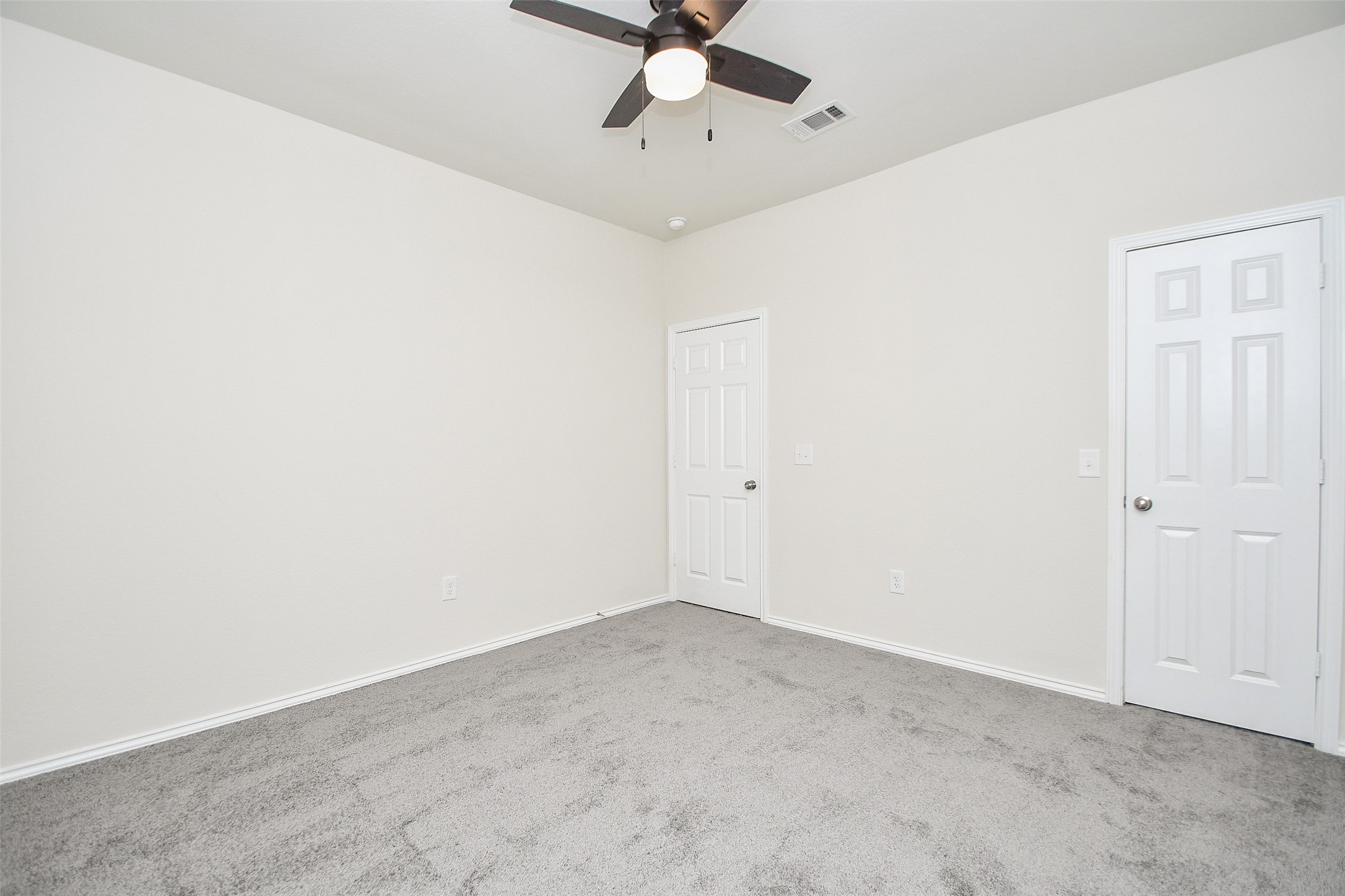 25918 Rustical Road Katy, TX 77493 - Photo 10 of 26 an empty room with a ceiling fan and carpet
