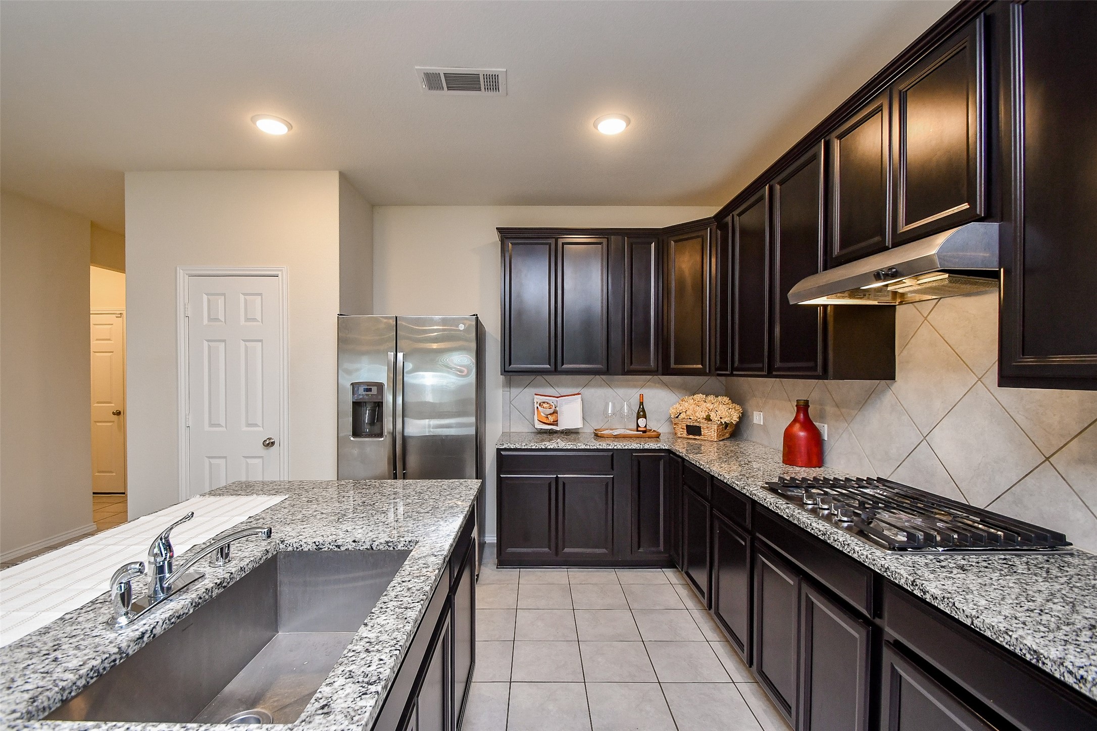 25918 Rustical Road Katy, TX 77493 - Photo 12 of 26 a large kitchen with stainless steel appliances granite countertop a sink stove and refrigerator