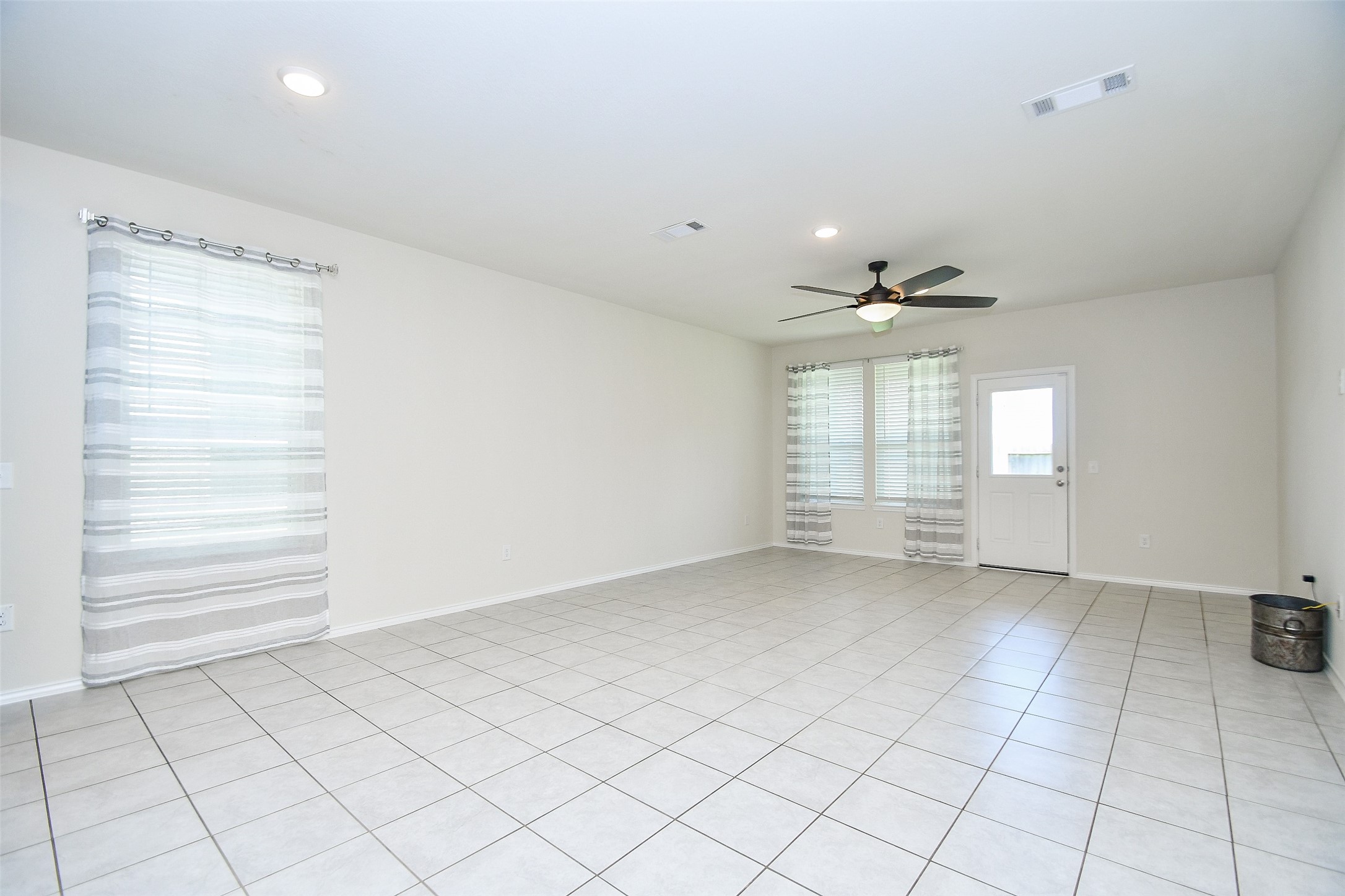 25918 Rustical Road Katy, TX 77493 - Photo 16 of 26 an empty room with windows and ceiling fan