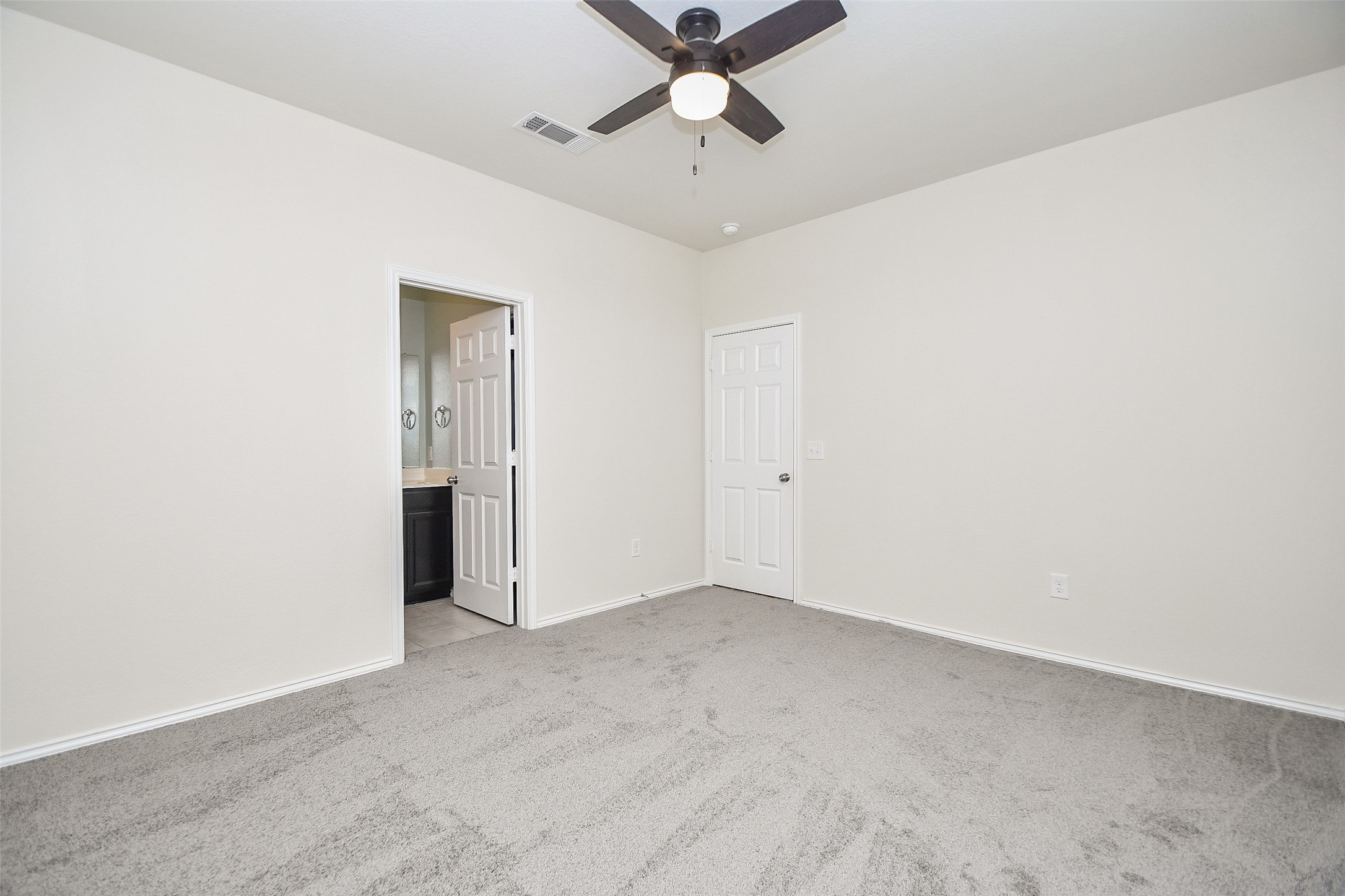 25918 Rustical Road Katy, TX 77493 - Photo 5 of 26 an empty room with a ceiling fan and carpet