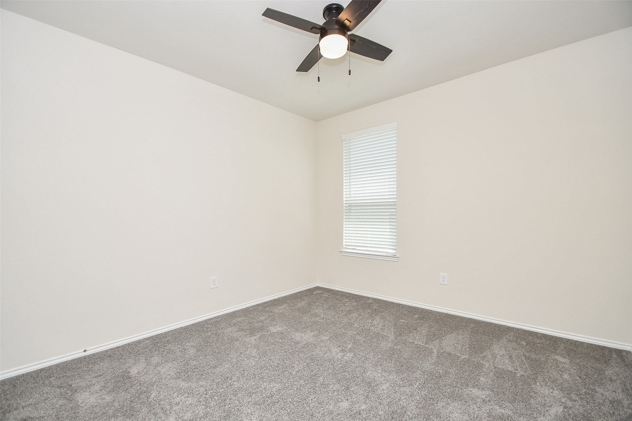 25918 Rustical Road Katy, TX 77493 - Photo 9 of 26 an empty room with a window and a fan