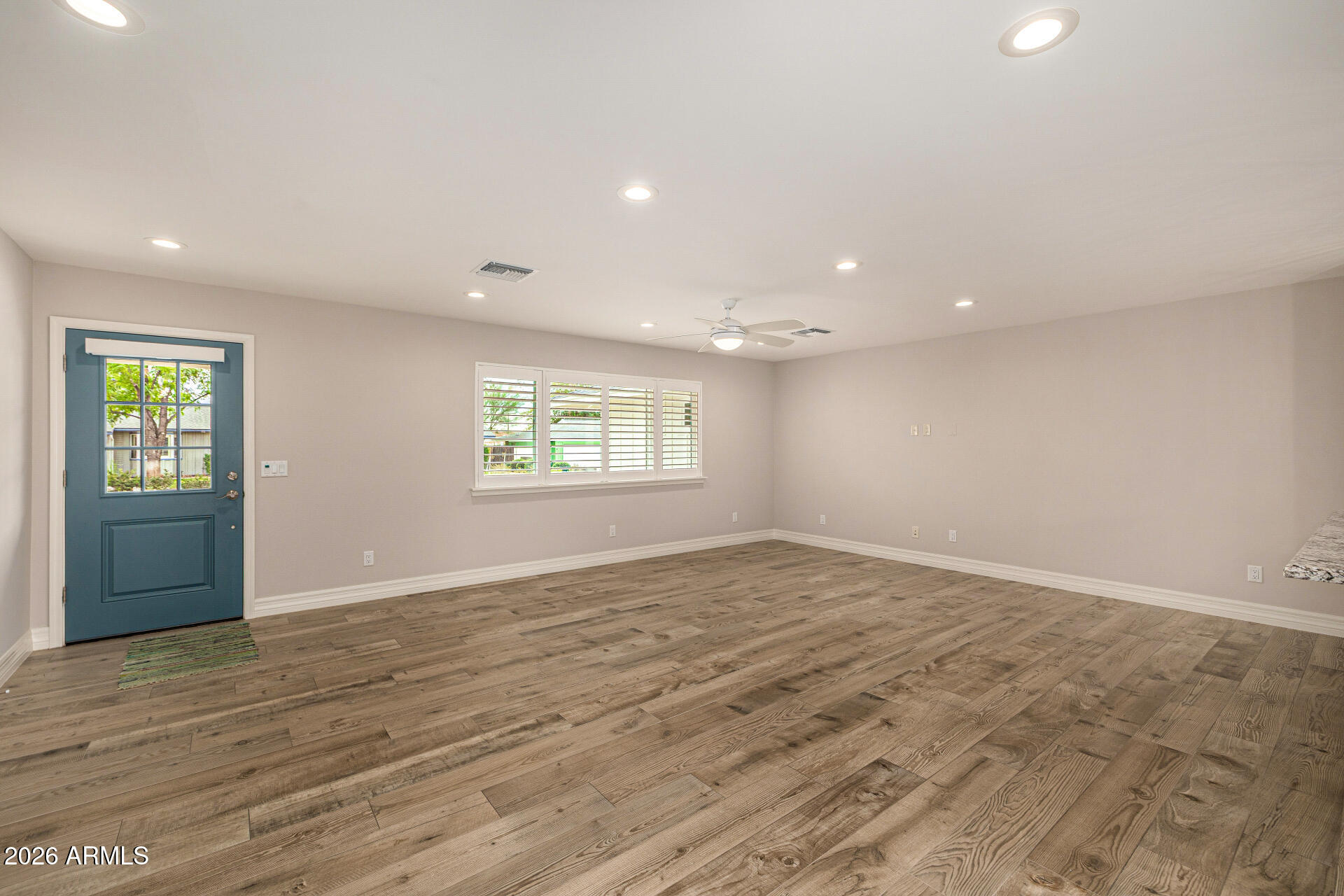4010 East Coolidge Street Phoenix, AZ 85018 - Photo 19 of 82 an empty room with wooden floor and windows