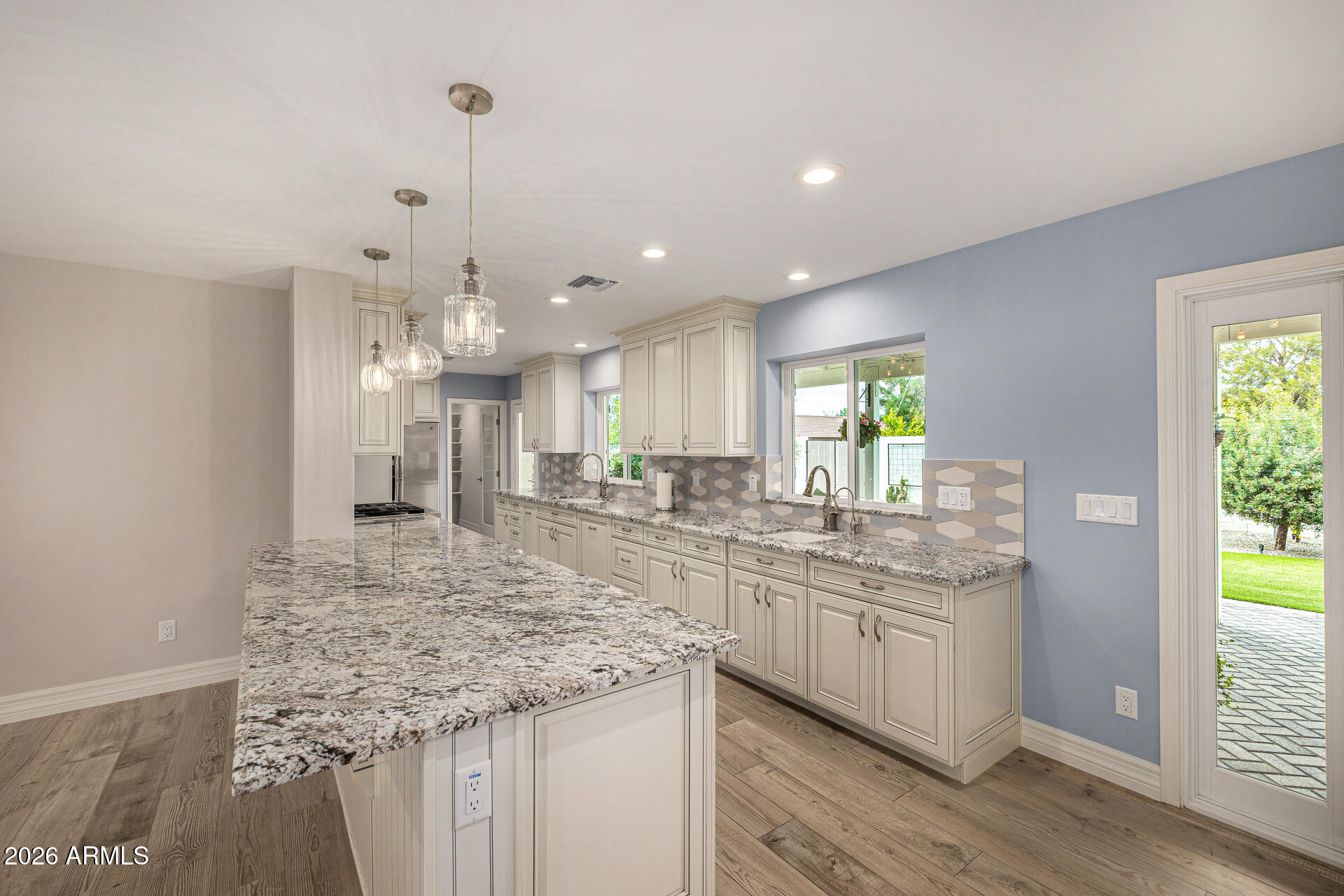 4010 East Coolidge Street Phoenix, AZ 85018 - Photo 25 of 82 a kitchen with stainless steel appliances granite countertop a sink and cabinets