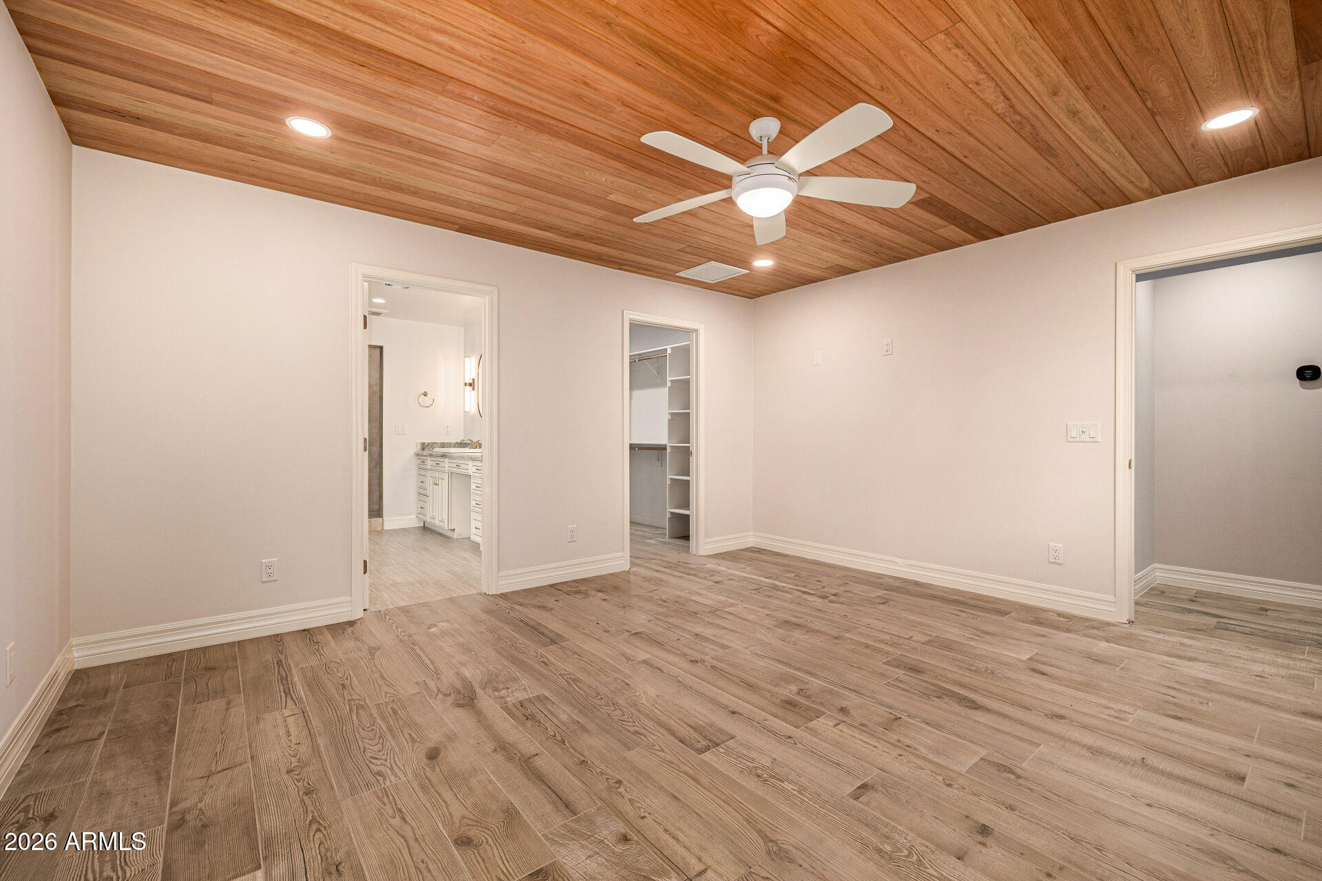 4010 East Coolidge Street Phoenix, AZ 85018 - Photo 36 of 82 an empty room with wooden floor fan and windows