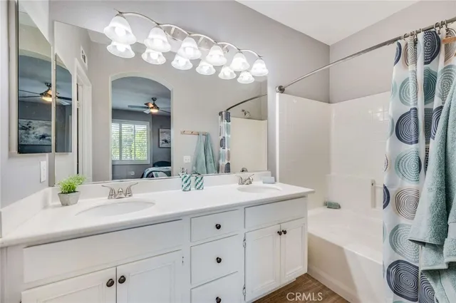 a bathroom with a sink a large mirror and a shower