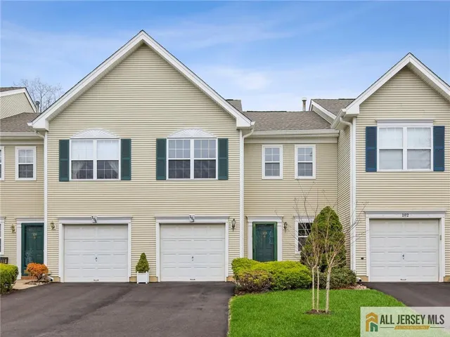a view of a house with a yard and garage