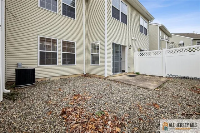 a front view of a house with a yard and potted plants