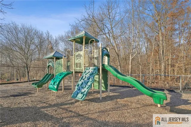 a view of a backyard with wooden fence