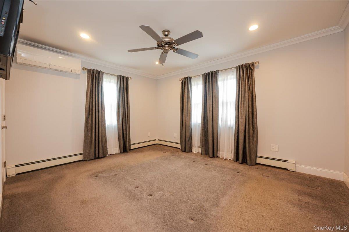 1674 Kroll Road East Meadow, NY 11554 - Photo 11 of 25 an empty room with closet and windows