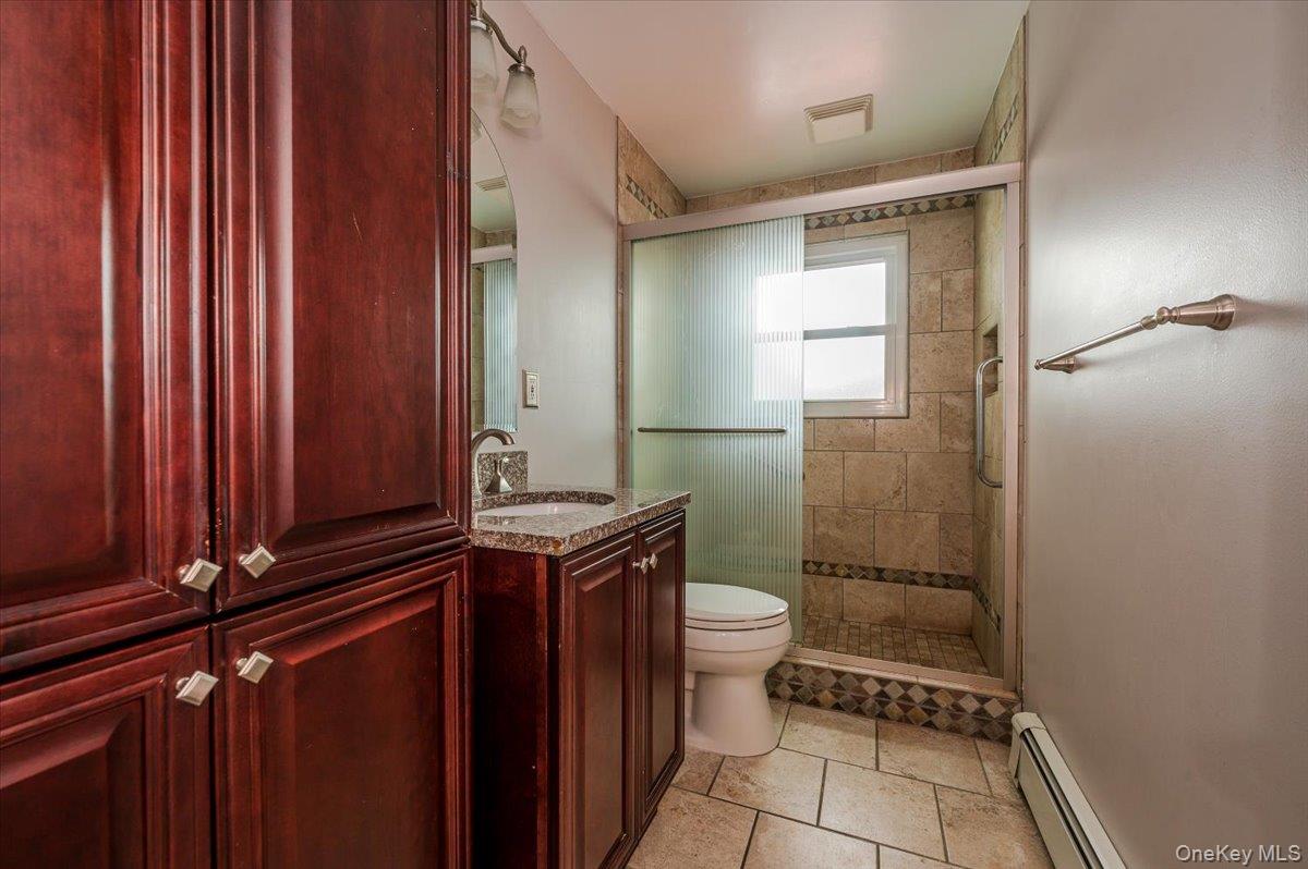1674 Kroll Road East Meadow, NY 11554 - Photo 13 of 25 a bathroom with a granite countertop sink toilet and shower