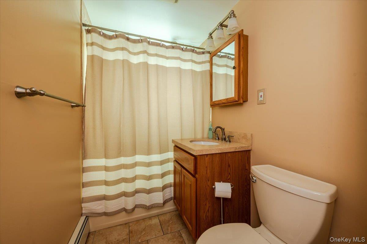 1674 Kroll Road East Meadow, NY 11554 - Photo 16 of 25 a bathroom with a granite countertop sink toilet and shower