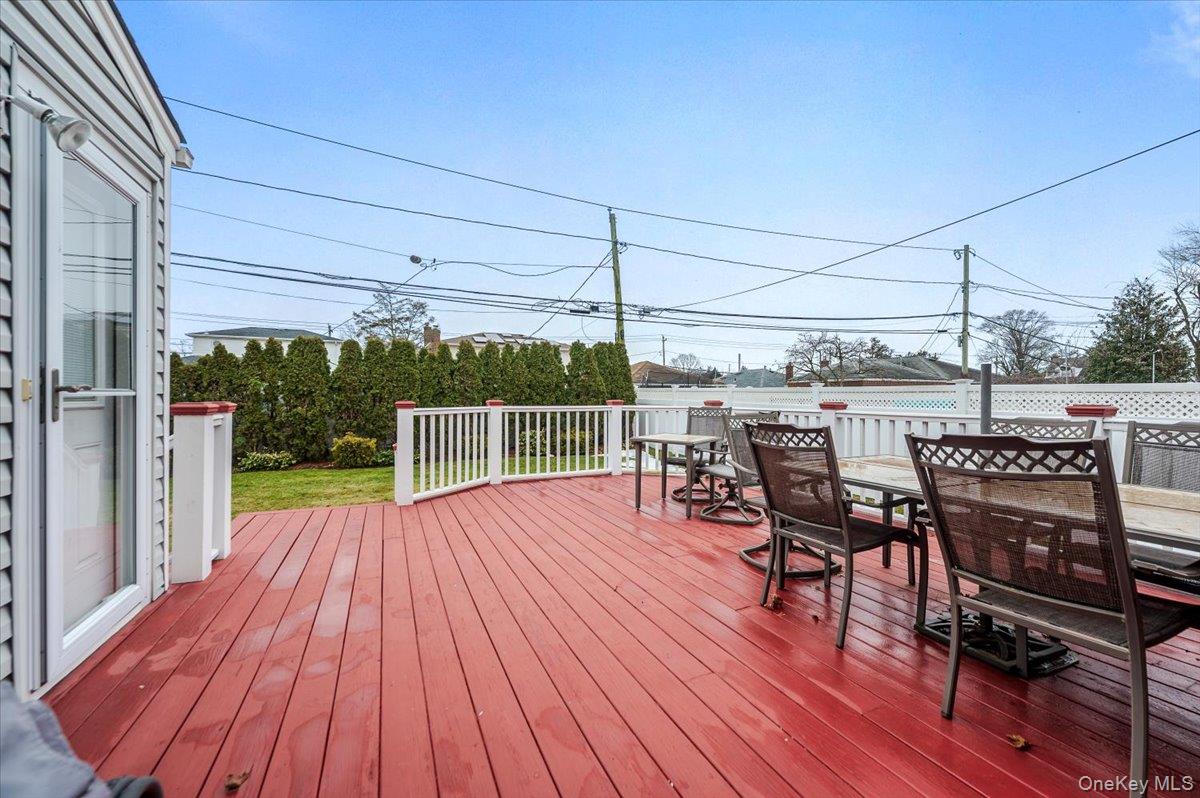 1674 Kroll Road East Meadow, NY 11554 - Photo 22 of 25 a view of a roof deck with table and chairs couches with wooden floor
