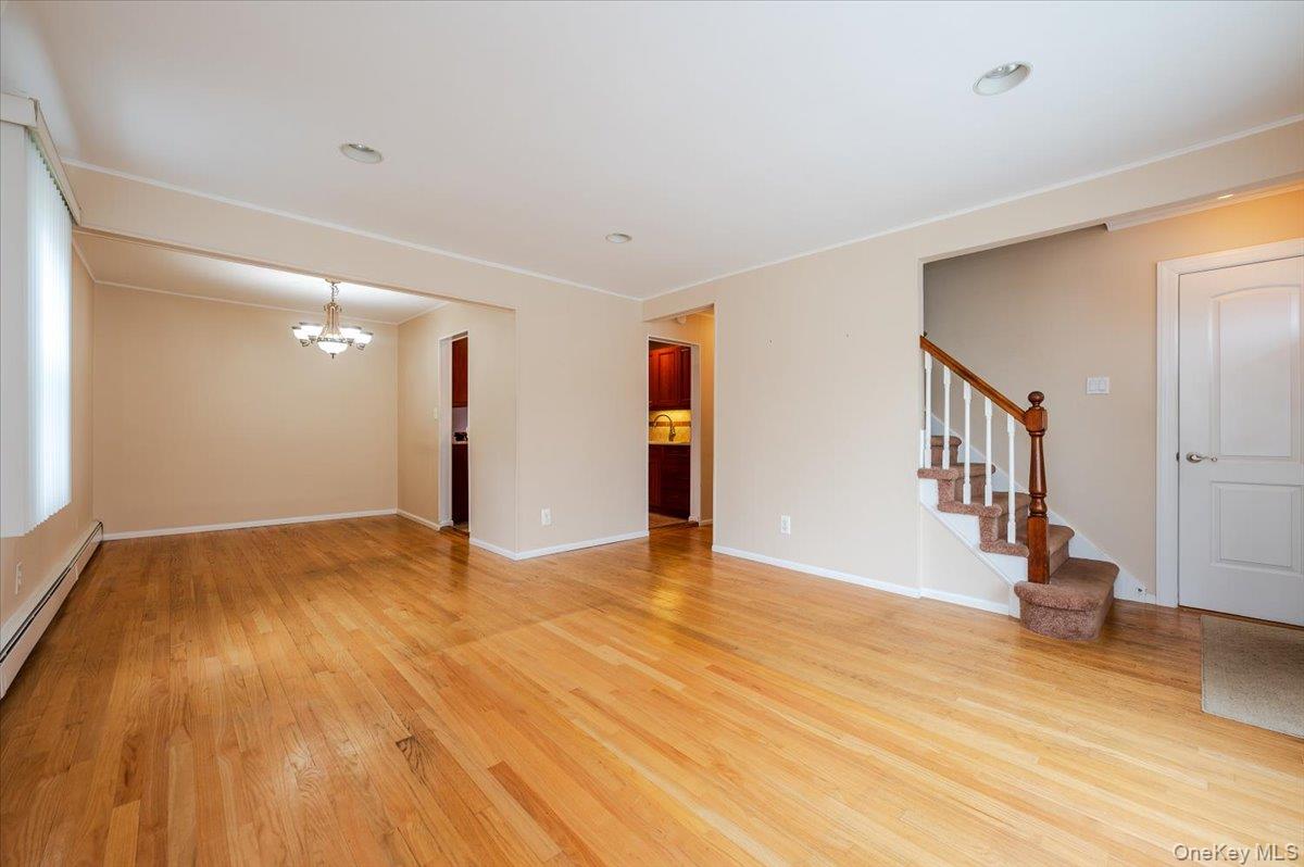 1674 Kroll Road East Meadow, NY 11554 - Photo 4 of 25 a view of an empty room with wooden floor and a window